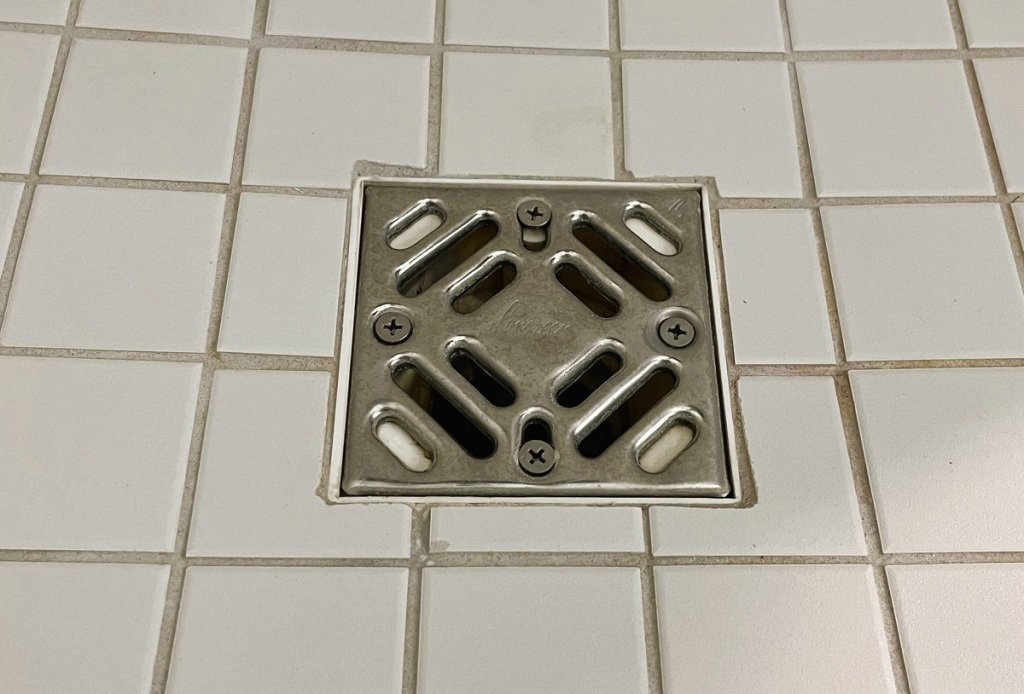 why does water back up in shower drain